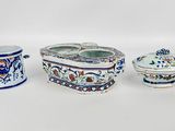 several different types of ceramic items are displayed on a white surface