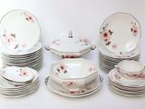 a lot of plates and bowls with flowers on them
