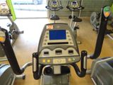 a row of stationary exercise bikes in a gym