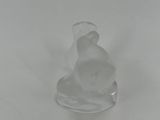 a glass figurine of a cat sitting on a table