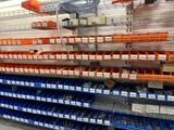 many bins on the shelves in the store
