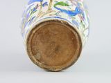 a vase with a floral design on it on a white surface