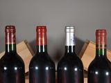 three bottles of wine are lined up in a row on a table
