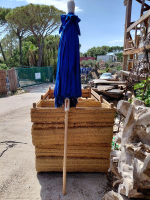 a blue umbrella sitting on top of a pile of wood