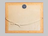 an old picture frame with a rope attached to it on a gray background