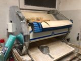 a machine that is cutting a sheet of paper on a table