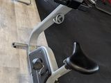 an image of a gym room with a row of stationary exercise bikes