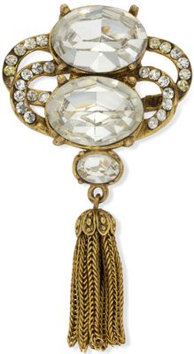 a close up of a broochle with a tassel on it