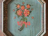 a close up of a picture of flowers in a frame on a table