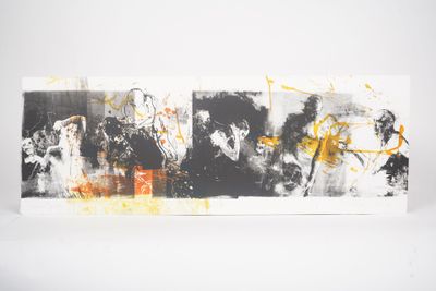 three black and white paintings with yellow paint on them on a white surface