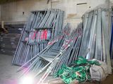 a pile of chairs and a pile of wires in a warehouse