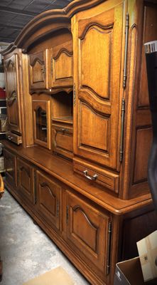 a large wooden cabinet in the middle of a room