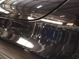 a close up of a car ' s bumper with a reflection on it