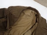 a bed with a brown blanket and a white blanket