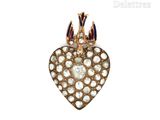 a close up of a heart shaped brooch with a crown on top of it
