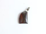 brown tiger eye stone pendant with a silver bail on a white background