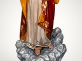 the statue of jesus is standing on a cloud with his hands out