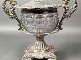 an ornate silver plated bowl with a lid on a stand