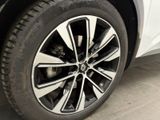a close up of a tire on a white car