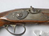 an old gun that is sitting on top of a table