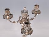 a silver candelab with three candles on it