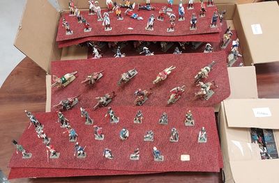many figurines of people in a box on a table