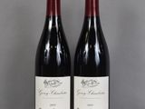 deux bouteilles de vin posées sur une table en verre