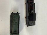 two toy trains sitting next to each other on a table
