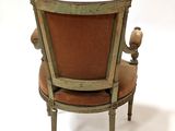 a chair that has a bird on the back of it