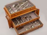 a wooden box with silverware in it on a table