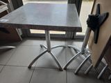 a small table and chairs in front of a glass door