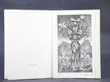 an open book with a black and white drawing of a man holding a bird