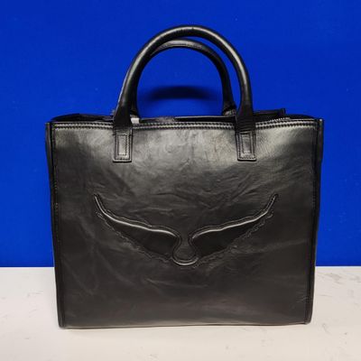 a black leather handbag with an eagle emblem on the front