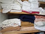 a closet with a lot of folded clothes on the shelves