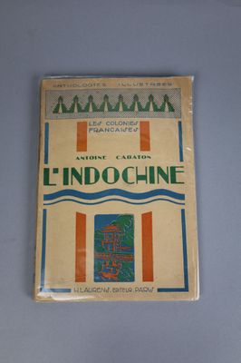 an old book sitting on top of a table next to a blue table