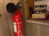 a fire extinguisor in the corner of a room