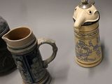 three beer mugs sitting next to each other on a table