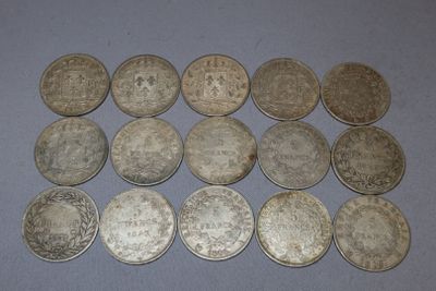 some silver coins are sitting on a table with a blue background