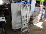 a lot of boxes and a ladder in a warehouse