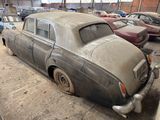 a old car that is sitting in a garage