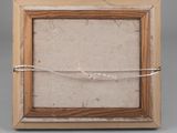 an old picture frame with a rope wrapped around it