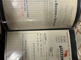 two menus sitting on a table in a restaurant