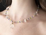 the woman is wearing a necklace made of glass beads and beads