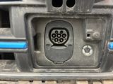 a close up of a car ' s front bumper with an electrical outlet