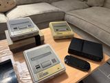 three nintendo classic game consoles sitting on top of a wooden table