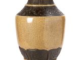 a vase that is sitting on a stand on a white surface