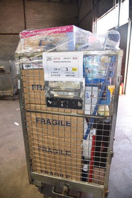 a cart full of items in a warehouse with a sign on it