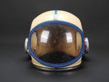 a close up of a helmet on a table with a black background