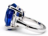 a close up view of a blue sapphire and diamond ring