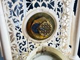 a white toilet with a gold bowl on top of it